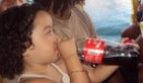 Little Brazilian girl drinking a full bottle of Coca-cola