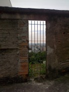 View of the city of Belo Horizonte from Mirante, Mangabeiras through an abandoned gate