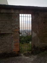 View of the city of Belo Horizonte from Mirante, Mangabeiras through an abandoned gate