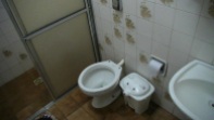 Note there is no toilet seat and a waste-paper bin for used toilet-paper