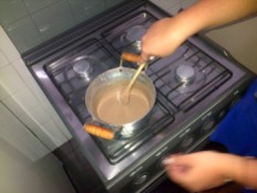 Warming up leite condensado in a pan to make Brigadeiros.