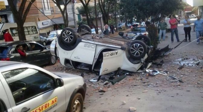 Car drives through wall of multi-storey car park and lands flipped upside down in road